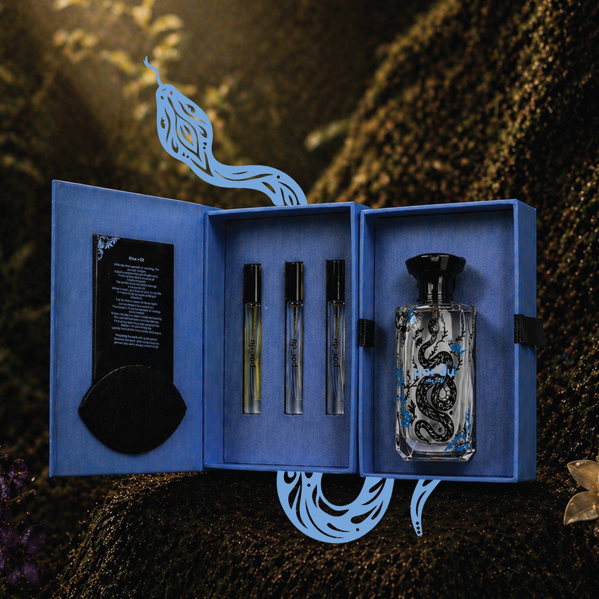 Perfume set with a blue box featuring a snake design on a dark background