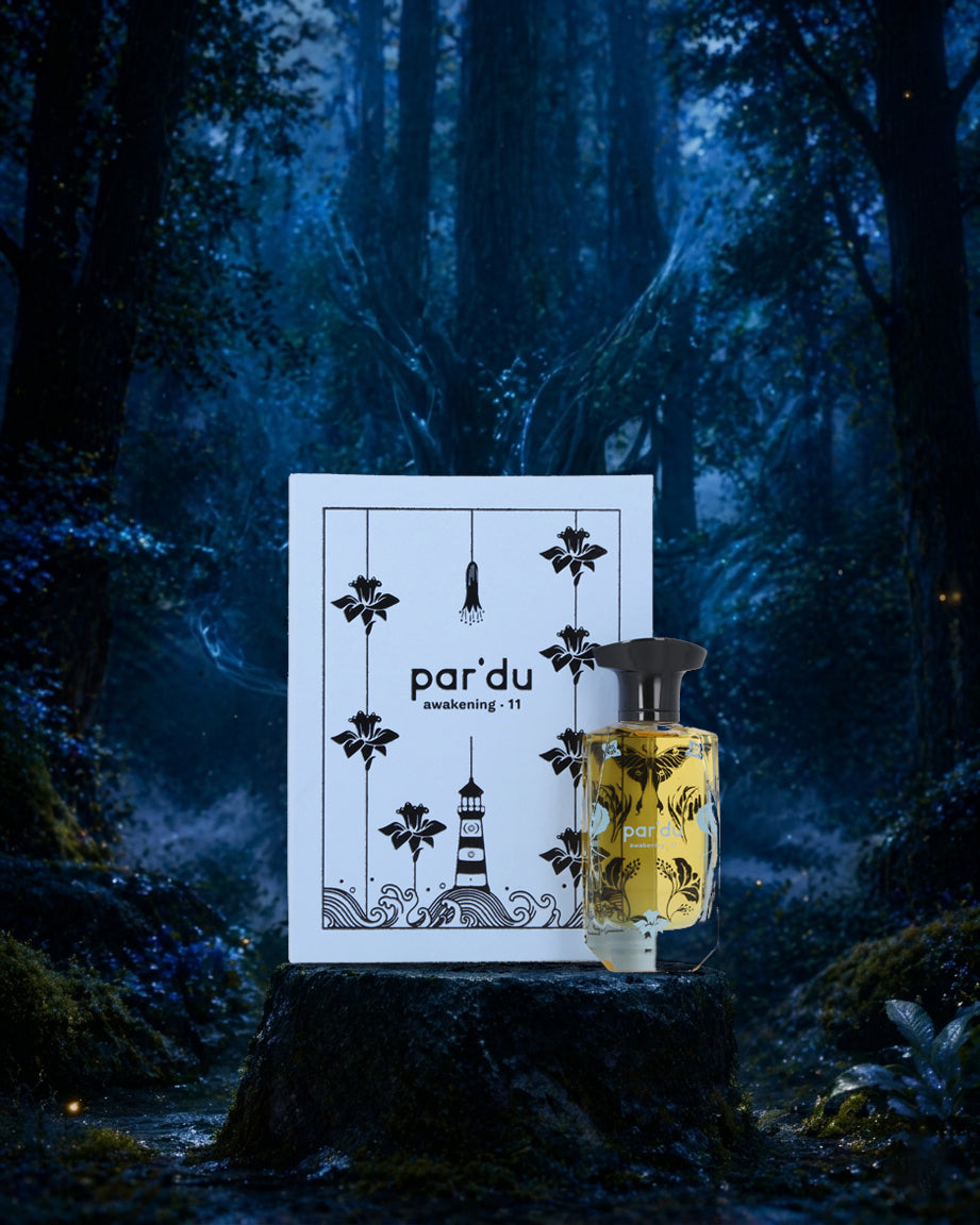 Perfume bottle with packaging labeled 'par'du' in a mystical forest setting